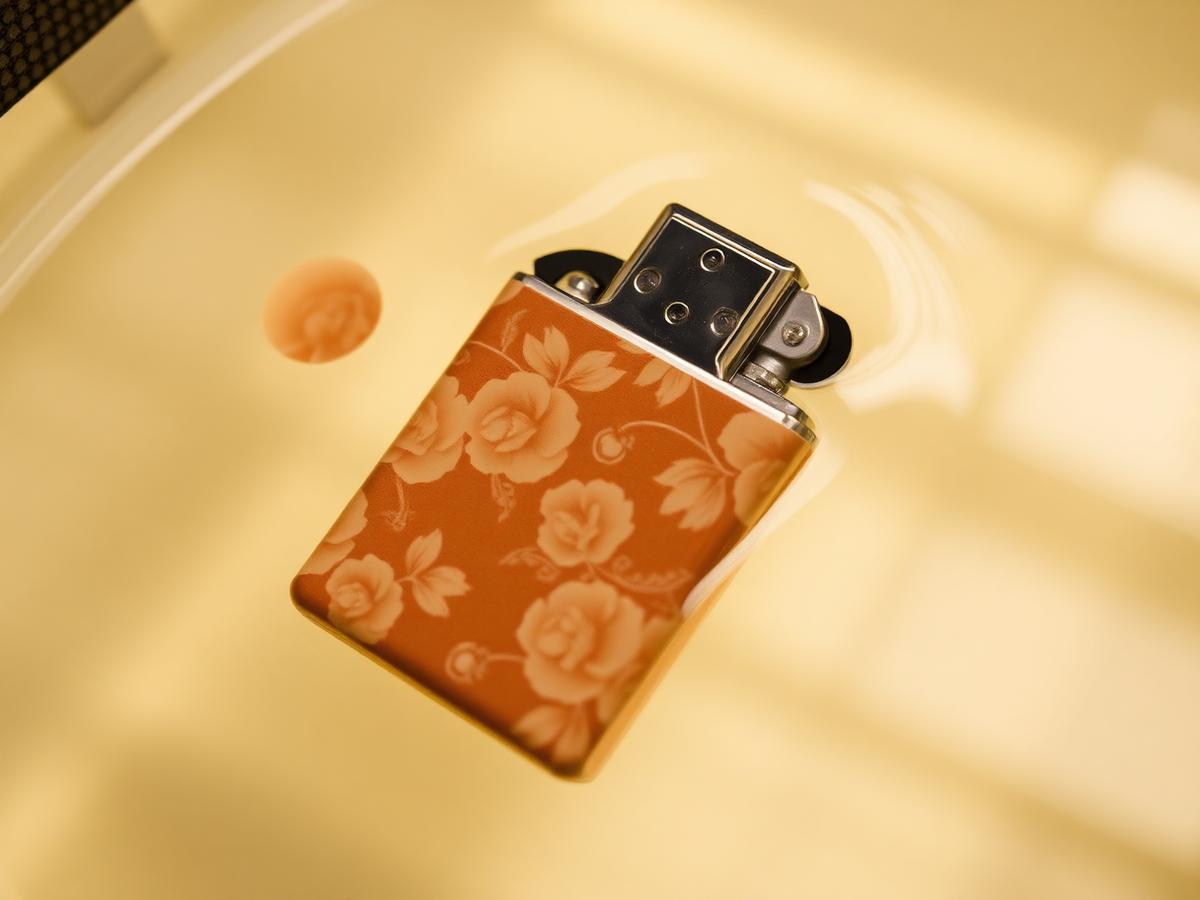 Floral hydrographic film wrapping a lighter casing in a dip tank